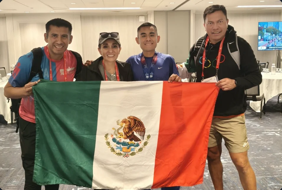 Jorge con su equipo sosteniendo la bandera de México tras el Maratón de Chicago